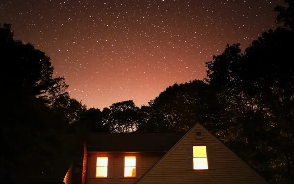 A starry night sky over a home - Kennebunk, Maine.