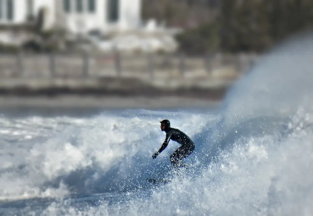 Photo of a surfer off the coast of Gooch's Beach, Kennebunk, Maine.
